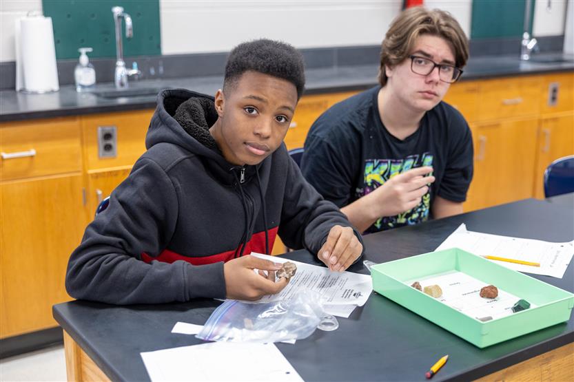 Students study rocks in a science lab
